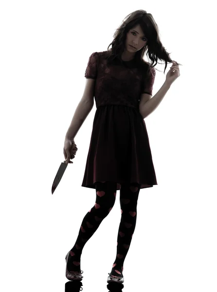 Strange young woman killer holding bloody knife silhouette — Stock Photo, Image