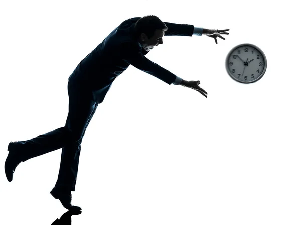 Business man running after clock silhouette — Stock Photo, Image