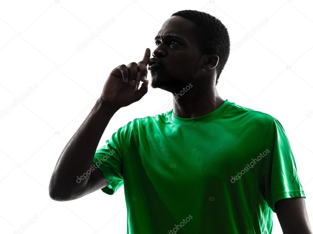 african man soccer player hushing silhouette