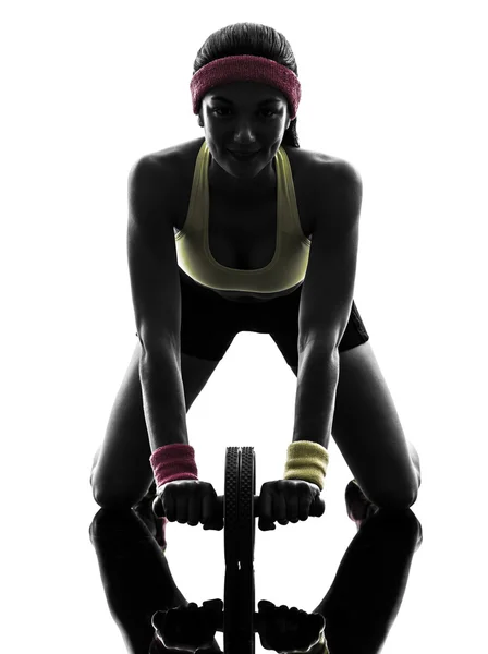 Woman exercising fitness workout abdominal toning wheel silhouet — Stock Photo, Image