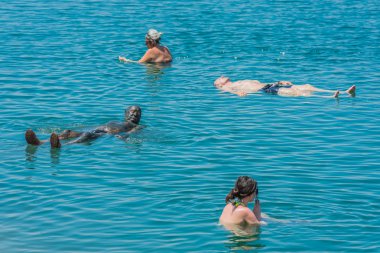 people swimming bathing in dead sea jordan clipart