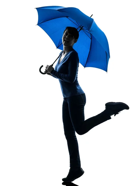 Woman happy holding umbrella silhouette — Stock Photo, Image