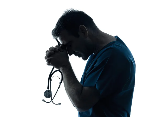 Doctor man praying silhouette portrait — Stock Photo, Image