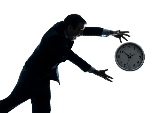Homme d'affaires courir après horloge silhouette — Photo