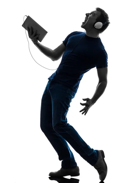 Man listening music digital tablet silhouette — Stock Photo, Image