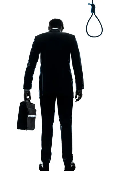 Business man standing in front of hangman noose silhouette rear — Stock Photo, Image