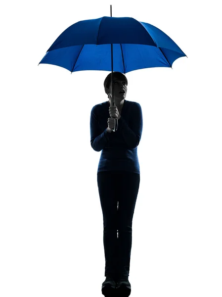 Anxious woman holding umbrella silhouette — Stock Photo, Image