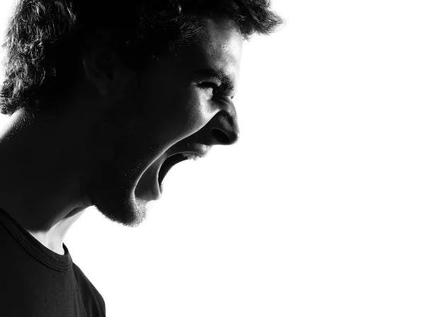 Jovem silhueta gritando retrato zangado — Fotografia de Stock