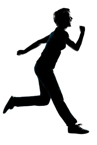 Uma jovem adolescente silhueta menina feliz correndo — Fotografia de Stock