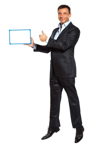 Um homem de negócios pulando segurando mostrando quadro branco — Fotografia de Stock