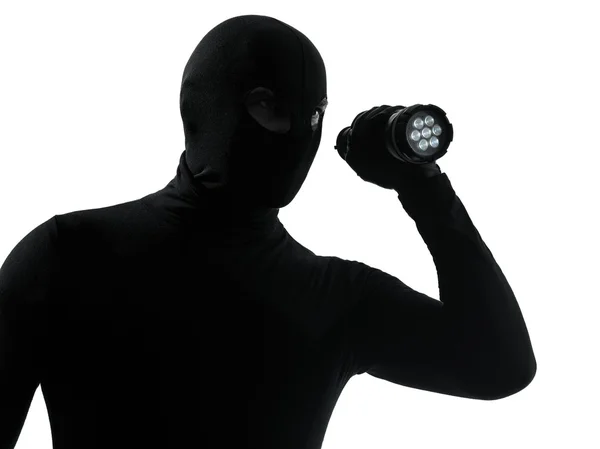 Thief criminal with flashlight silhouette — Stock Photo, Image