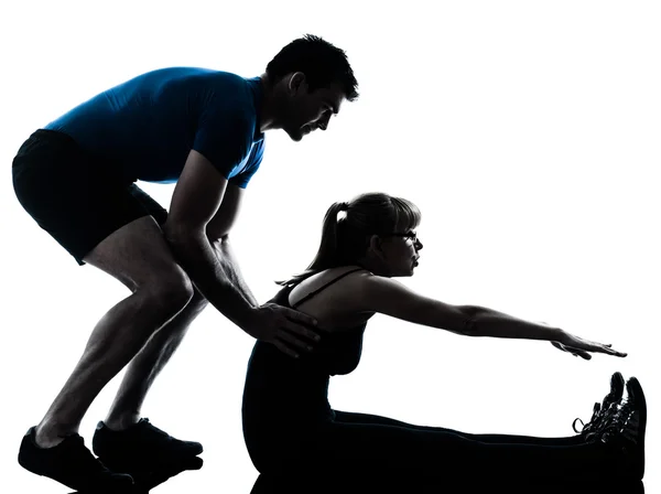 Aerobics intstructor with mature woman exercising silhouette — Stock Photo, Image