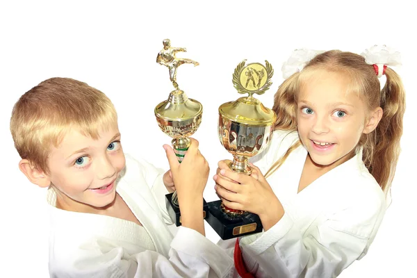 Chłopiec i dziewczynka w kimono z championship wygrywając w rękach — Zdjęcie stockowe