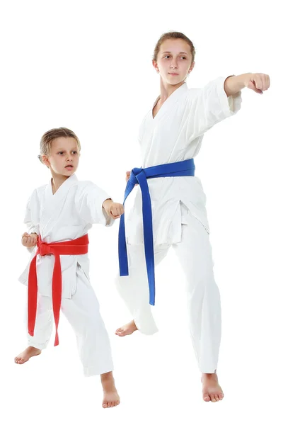 Two sisters athletes in kimono punch hand — Stock Photo, Image