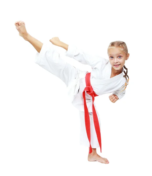 Ragazza atleta in un kimono esegue un calcio circolare isolato — Foto Stock