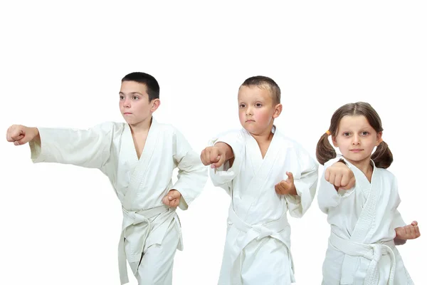 The girl and two boys in kimono beat punch arm — Stock Photo, Image