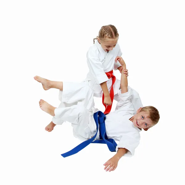 Girl in a kimono throws the boy in a kimono isolated — Stock Photo, Image