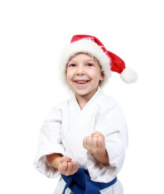 sporcu bir kimono ve beanie Noel Baba'nın bir ellerini savunma üzerinde tutar.