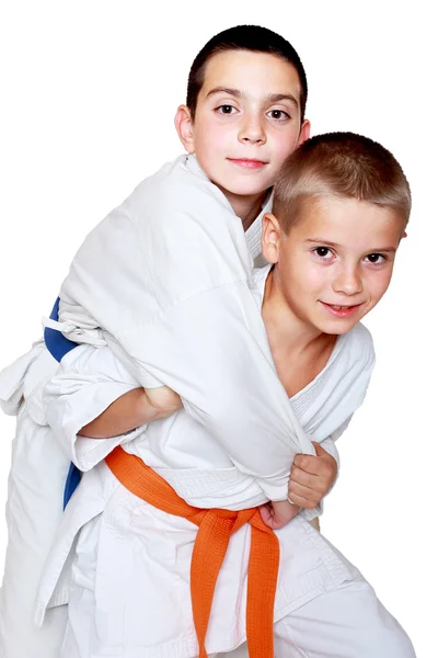 An athlete with an orange belt done a grab for throwing athlete with a blue belt — Stock Photo, Image