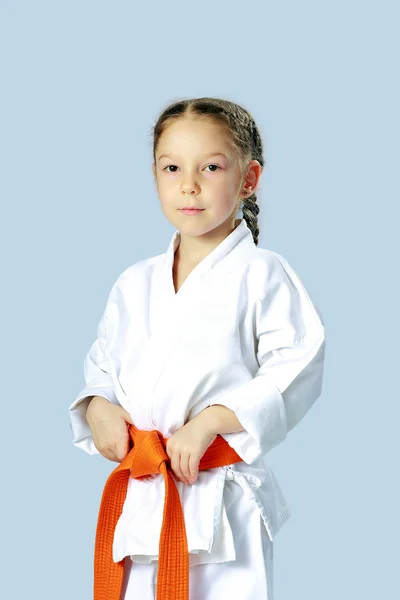 Athlete girl in a kimono with orange belt — Stock Photo, Image