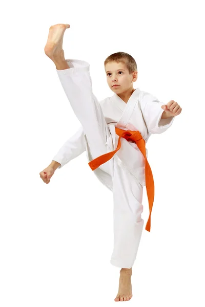 Boy in a kimono beat a high leg kick — Stock Photo, Image