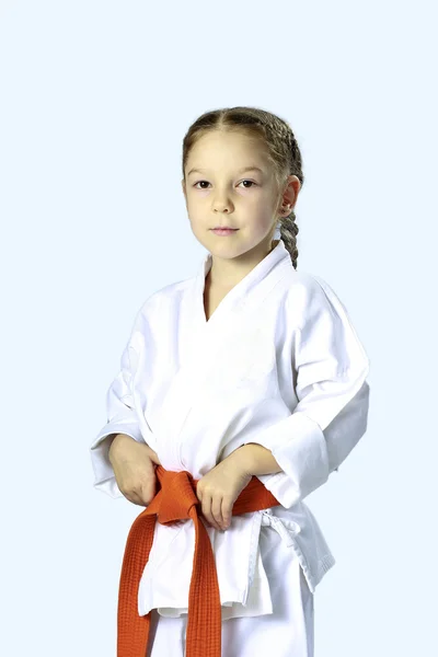 Little serious girl in a kimono with orange belt — Stock Photo, Image