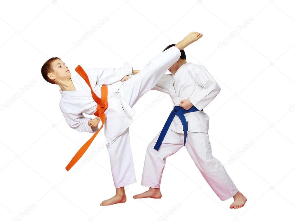 Athletes karate are training paired exercises on a white background