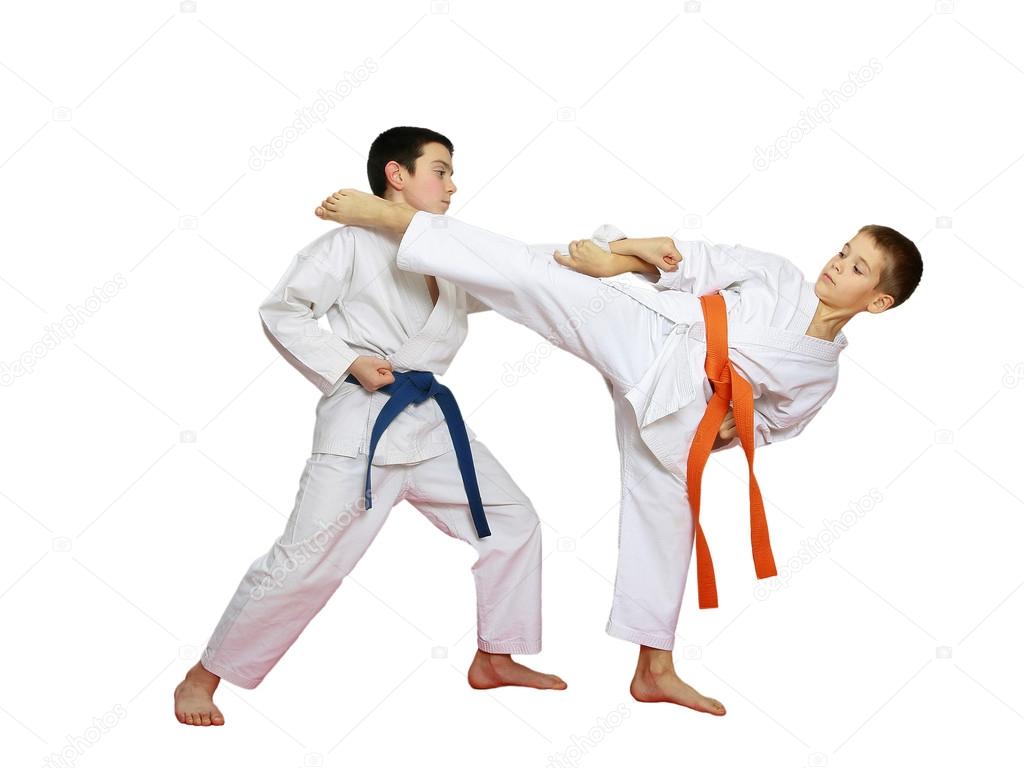 Technique karate in perform athletes with orange and blue belt
