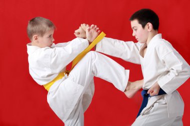 blok eller ve darbe tekme ile mavi kemer ile bir atlet karşı sarı kuşak sporcu gerçekleştirme
