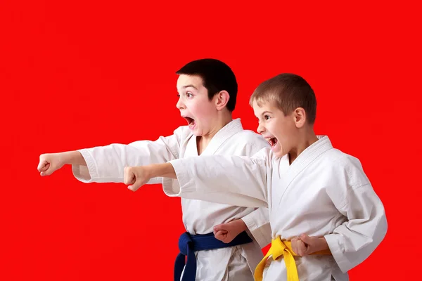 Straight punches hands in the performance of athletes in a kimono — Stock Photo, Image