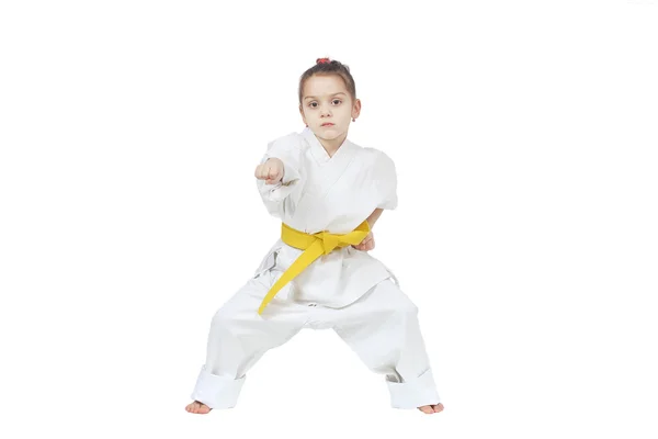 With yellow belt a little sportwoman is beating punch hand — Stock Photo, Image