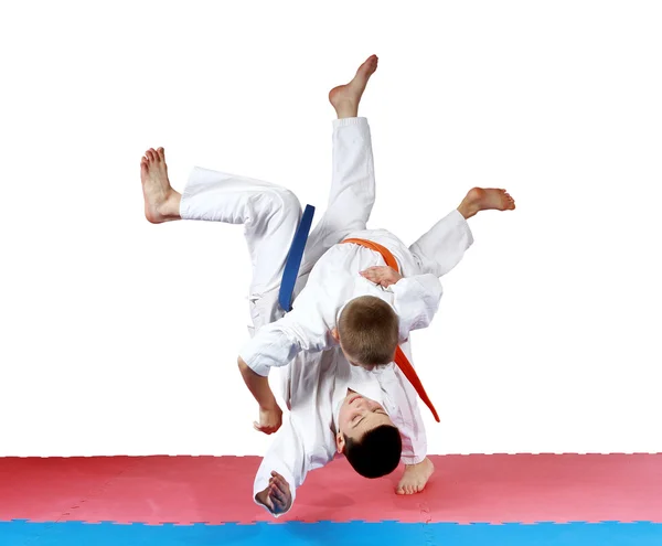 Active small athletes in kimono make tall throw — Stock Photo, Image