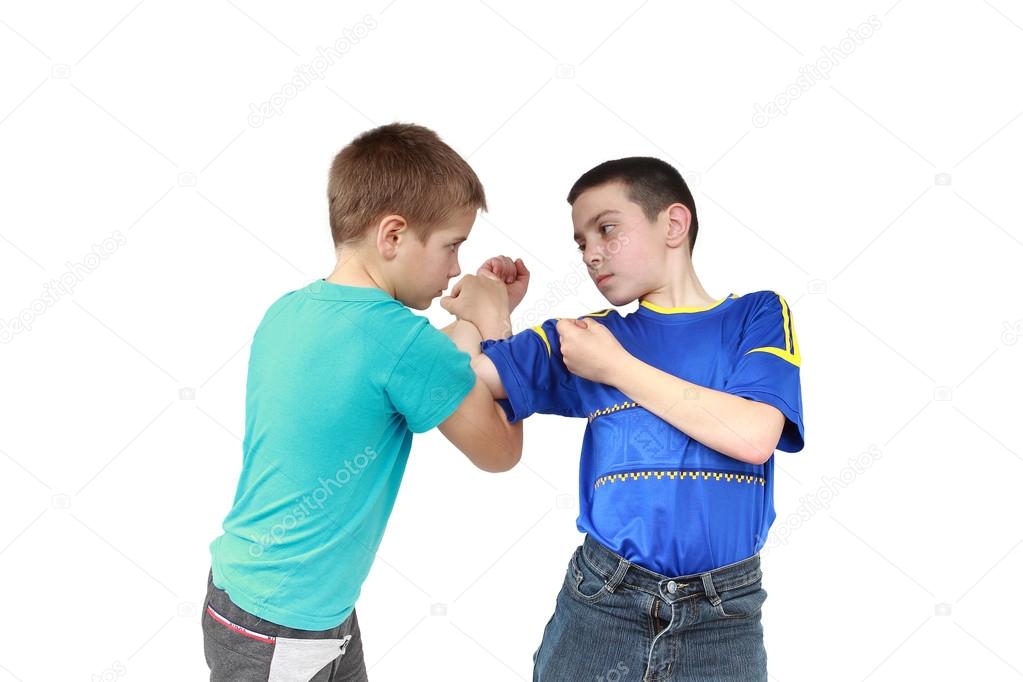 On a white background two boys in sportswear clothing is performing tricks