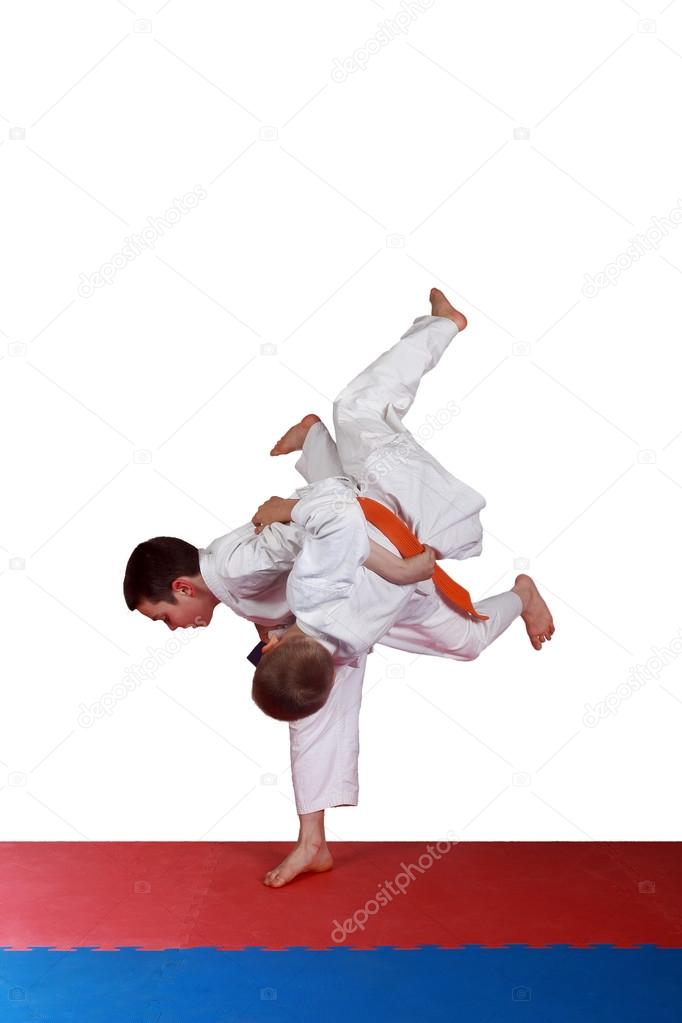 Training a throw judo athletes in  white kimono
