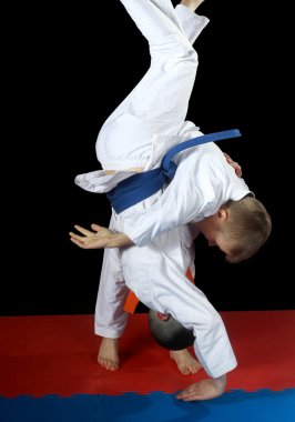 High throw uki-goshi in the performance athlete with orange belt clipart