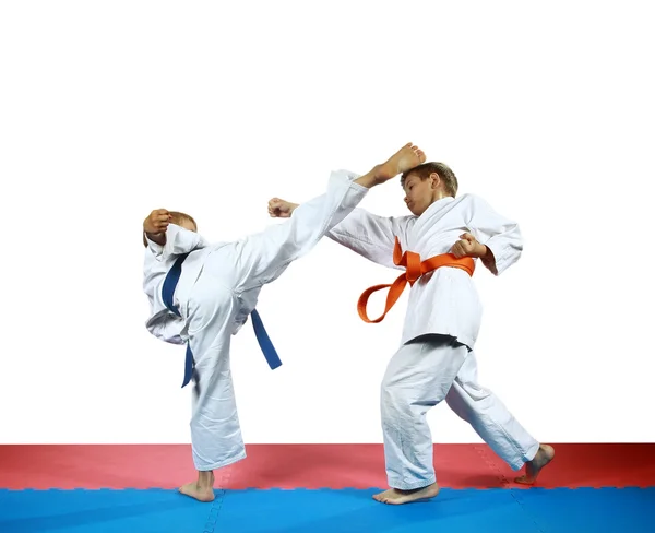 Small two athletes are training punch arm against blow leg — Stock Photo, Image