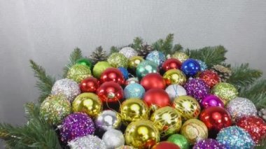 Birçok renkli Noel baloları açık arkaplanda döner