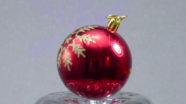 Red Christmas Ball Rotates Light Background — Stock Video