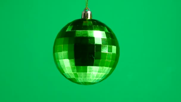 Green Checkered Ball Spinning Green Plain Background — Stock Video
