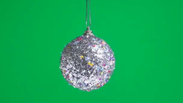 Silver Christmas Toy Ball Decorated Stars Spinning Green Plain Background — Stock Video