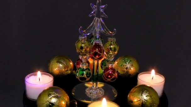 被燃烧的蜡烛和运动中的球环绕的小圣诞树 — 图库视频影像