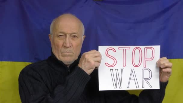 Elderly Man Standing Background Ukrainian Flag Raises Stop War Sign — Stock Video