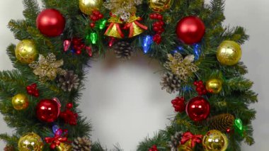 Close up of Christmas wreath candle vase with balls and fir tree
