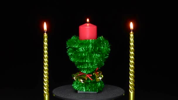 Black Background Decorated Candle Rotates Green Rain Two Candles — Stockvideo
