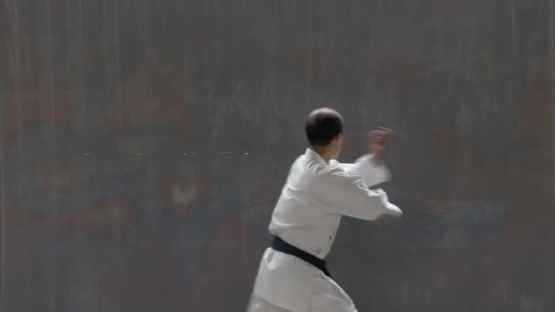 Young Sportsman Blue Belt Performs Formal Exercises Street Wall Background — Stock videók
