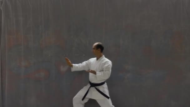 Young Sportsman Blue Belt Doing Formal Exercises Background Street Wall — Vídeo de Stock