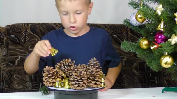 Little Boy Puts Christmas Decorations Spinning Stand — Vídeos de Stock