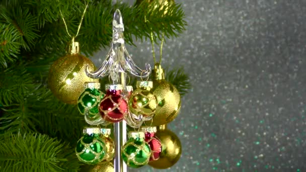 Small Christmas Tree Rotates Large Decorated Christmas Tree — Video Stock