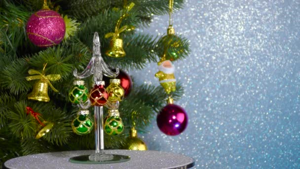 Small Christmas Tree Rotates Large Decorated Christmas Tree — Stock Video