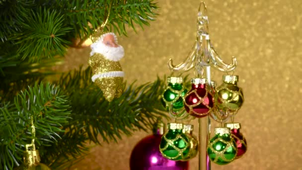 Small Christmas Tree Rotates Large Decorated Christmas Tree — Stockvideo